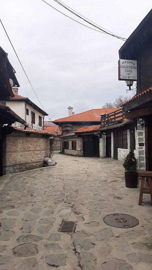 Walking through the historic Old Town of Bansko with traditional Bulgarian architecture on every side