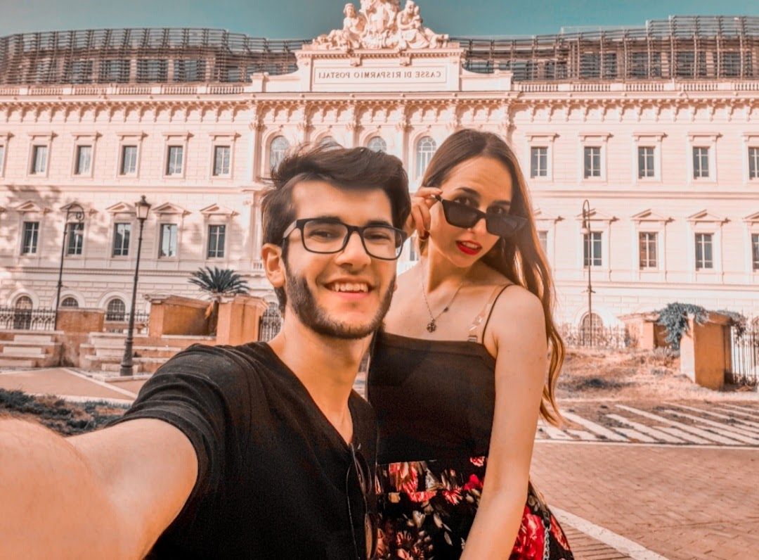 A romantic couple moment in Rome as the evening light bathes the eternal city in golden hues