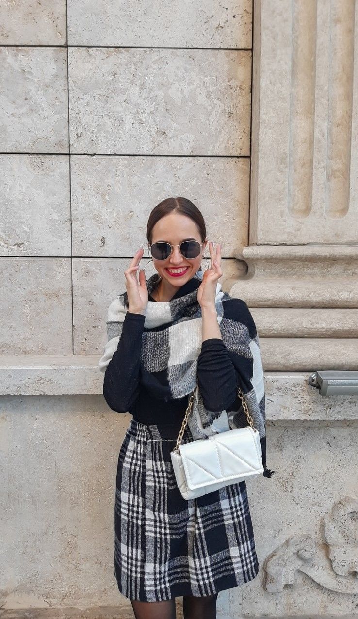 Dark tights paired with a plaid skirt and a beret creating a classy and warm autumn combination