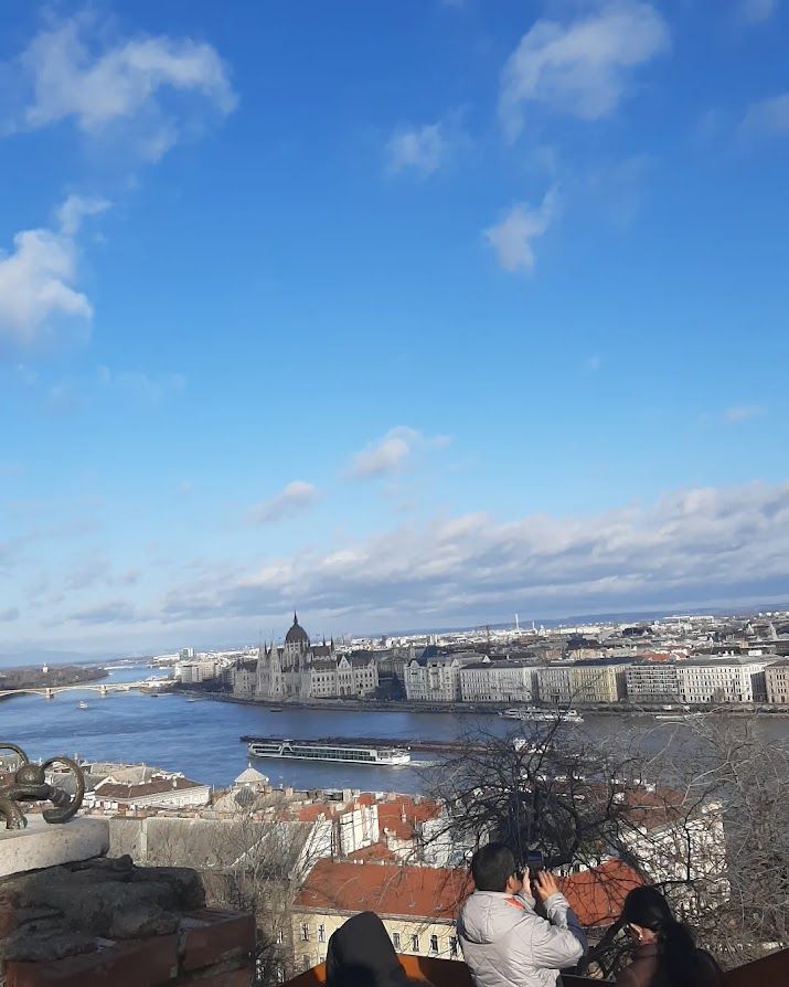 The majestic Buda Castle overlooking the beautiful blue Danube flowing through Budapest