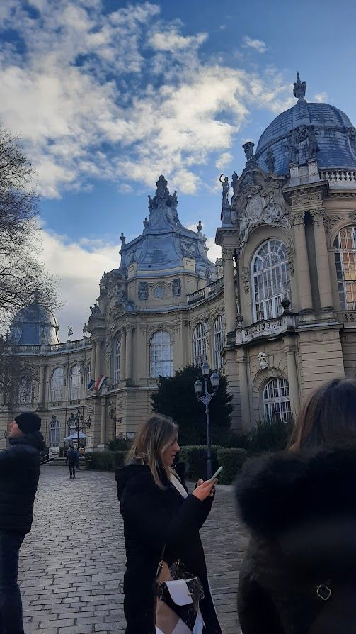 An elegant building in Budapest with intricate architectural details preserved from centuries past