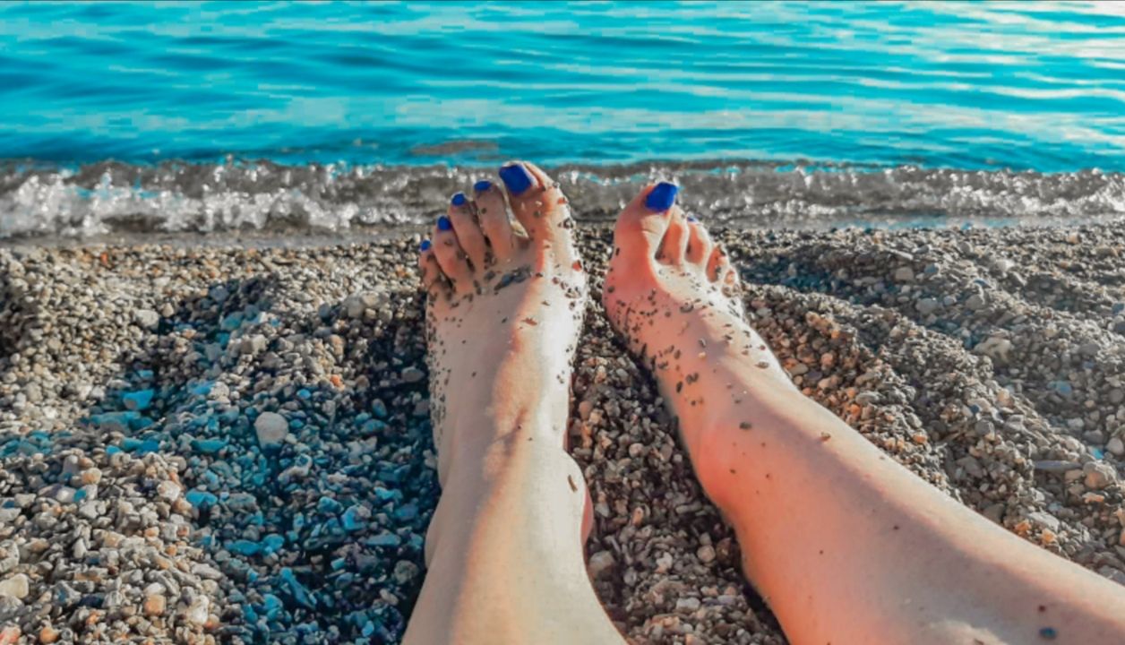 The beautiful St Naum beach area with pristine water and lush greenery surrounding the shoreline