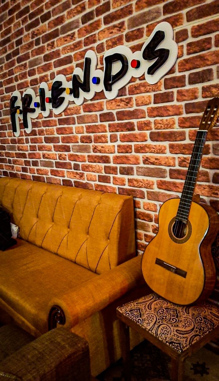 The cozy couch seating at Central Perk Skopje just like the famous orange sofa from Friends