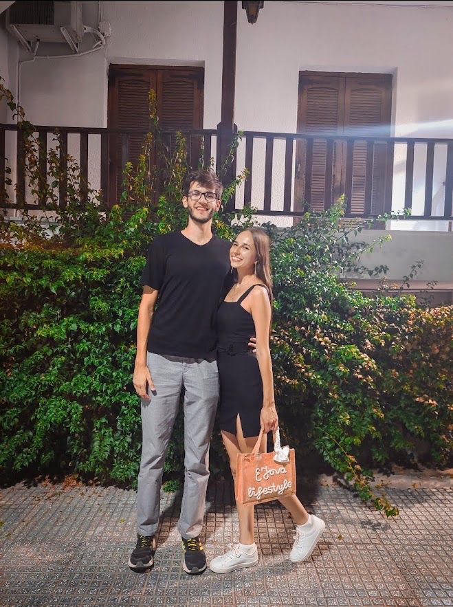 A beautiful couple evening by the Greek seaside enjoying the warm summer night atmosphere