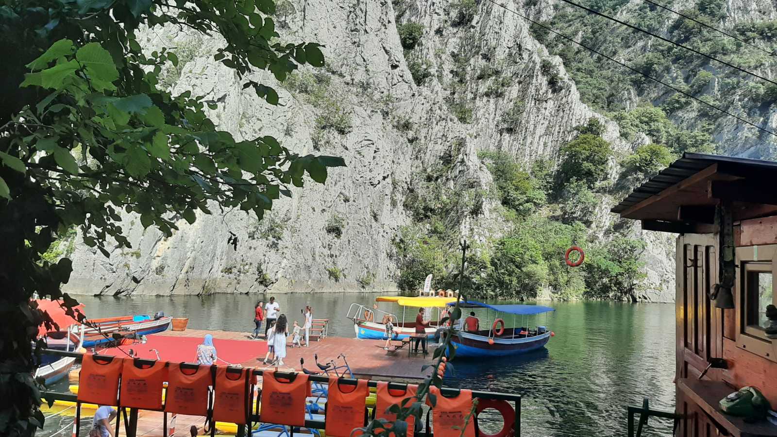 A stunning landscape view of Canyon Matka with emerald green water and steep rocky cliffs