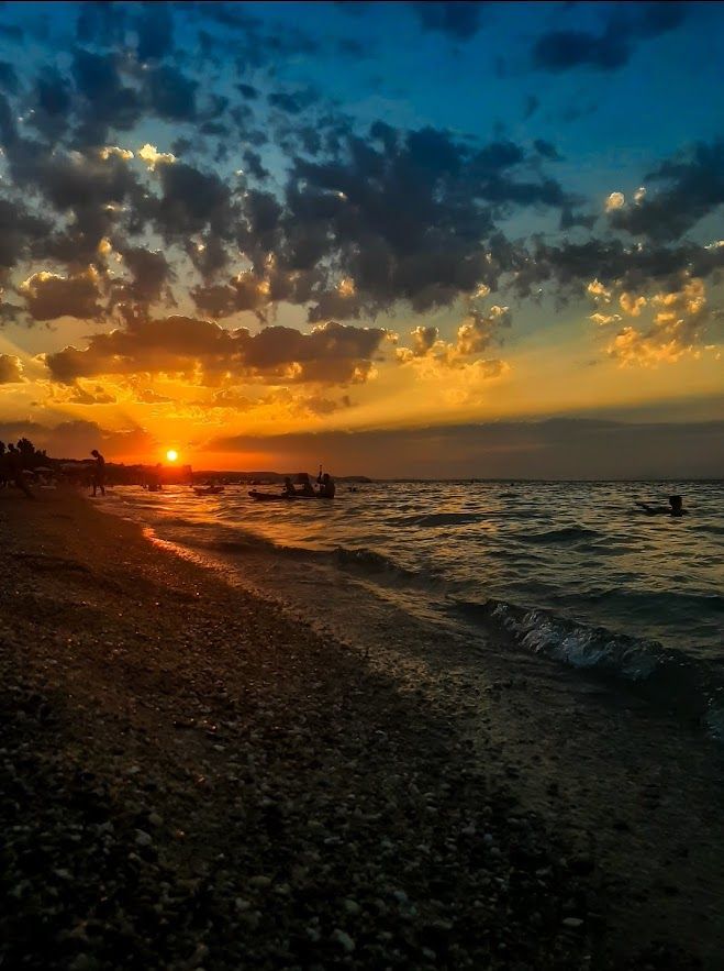 Warm sunset light dancing on the gentle sea waves along the Greek coastline