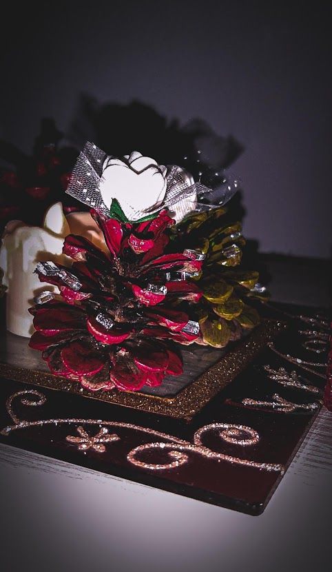 A decorative basket filled with painted pine cones and holiday ornaments for a natural Christmas look