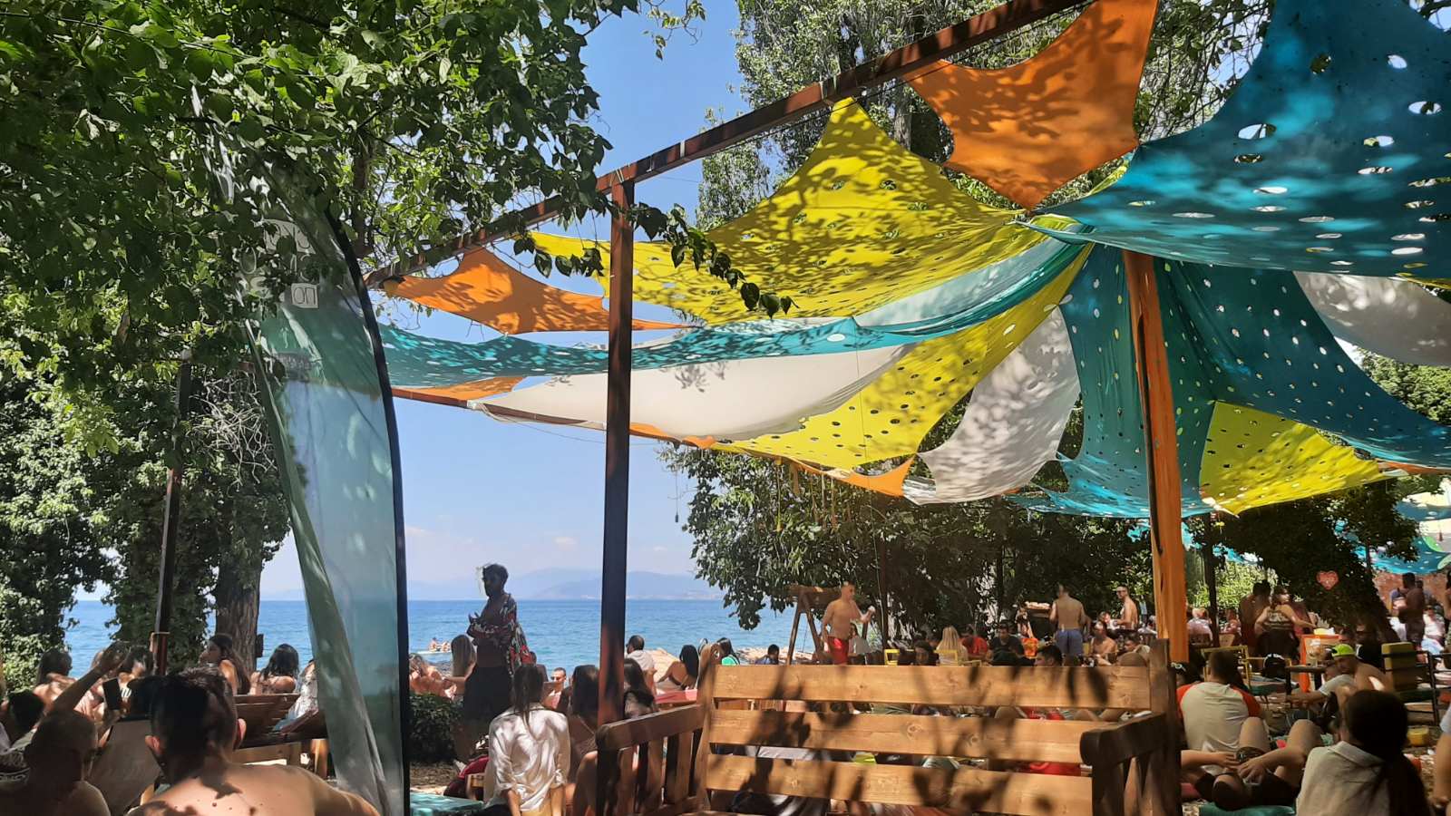 The sandy Gradiste Beach along the Ohrid Lake shoreline with clear water and sun umbrellas