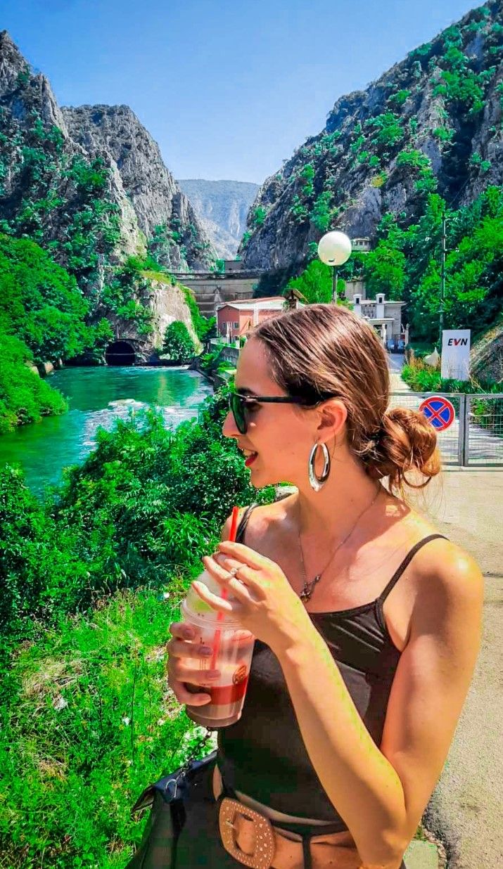 An ancient stone monastery built into the rocky cliffs of Canyon Matka overlooking the lake