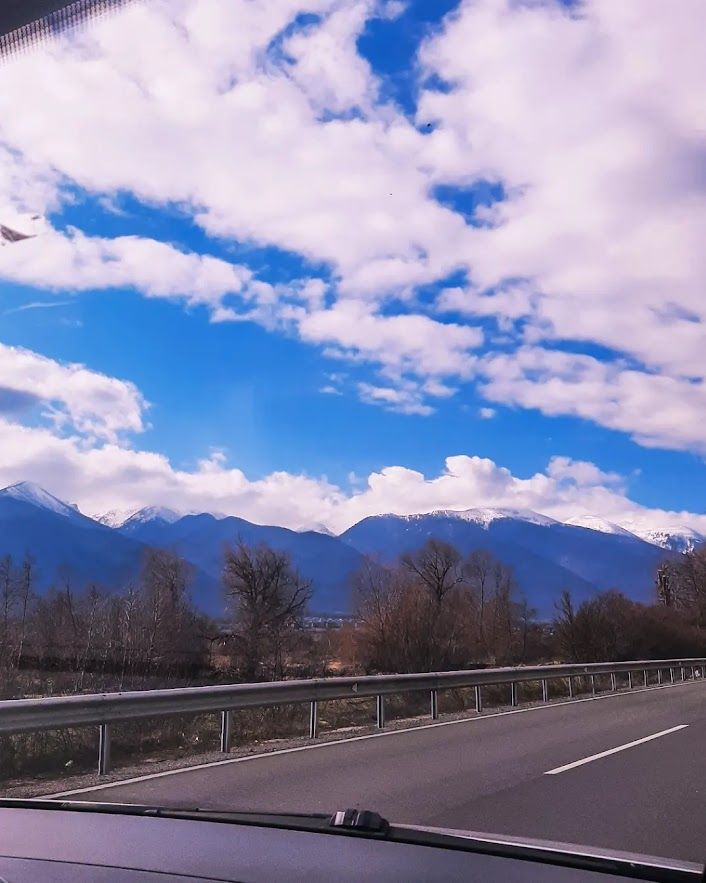 Driving through the mountain roads with the beautiful Pirin Mountains in the distance