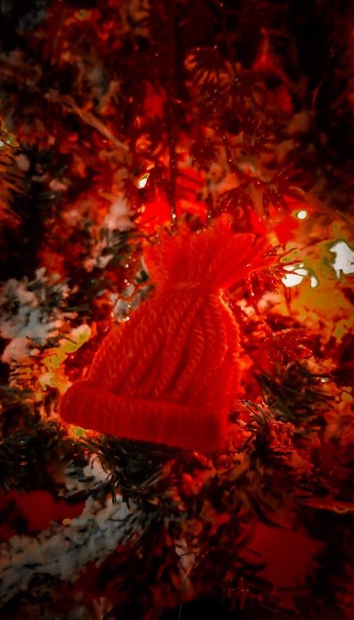 A beautifully wool-wrapped Christmas ornament adding a cozy handmade touch to the holiday decor