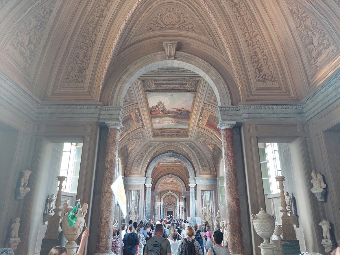 A gallery in the Vatican Museums showcasing art from the hands of Raphael Michelangelo and da Vinci