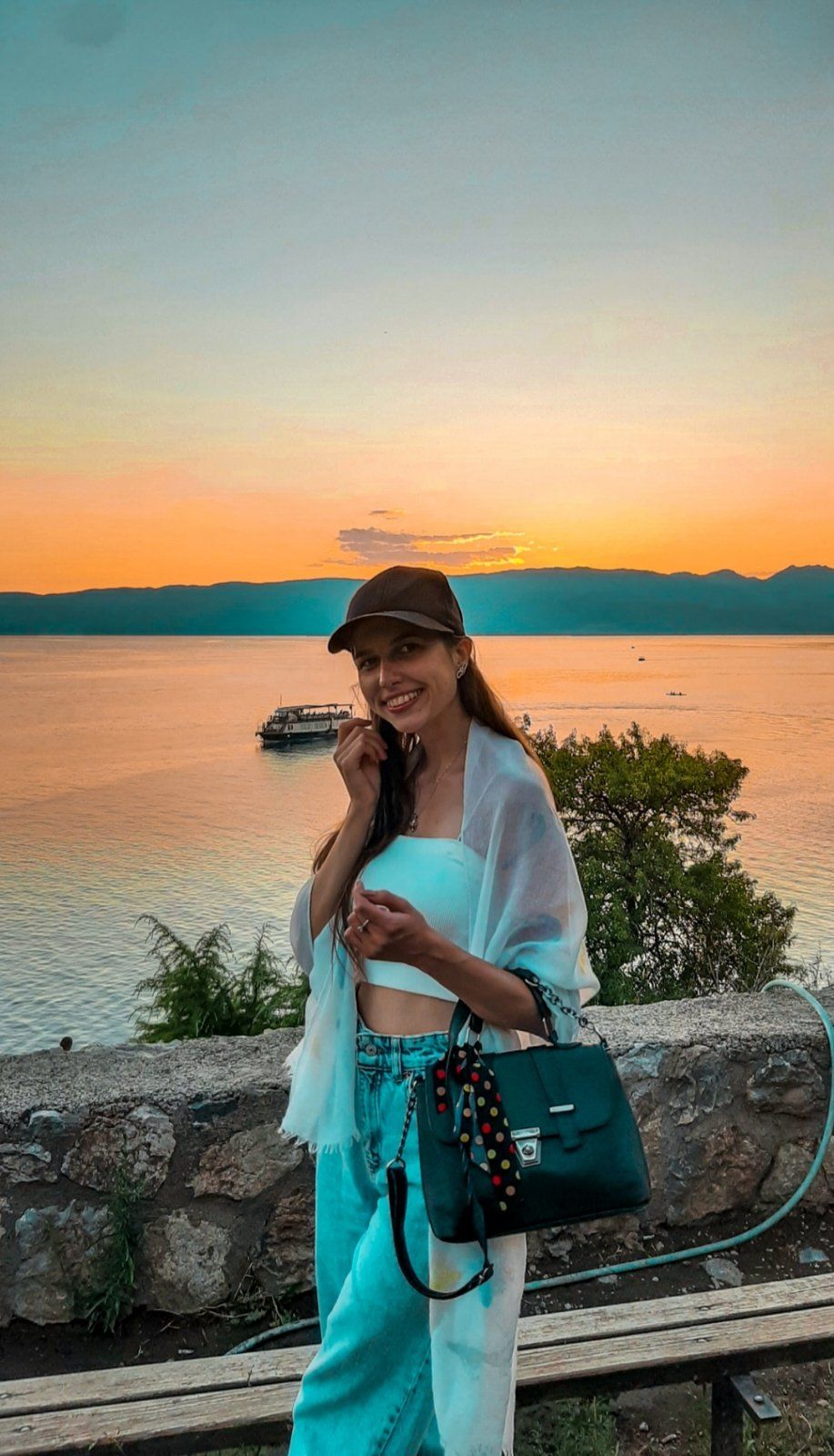 A breathtaking sunset viewed from Kaneo with golden light illuminating Ohrid Lake and the surrounding mountains