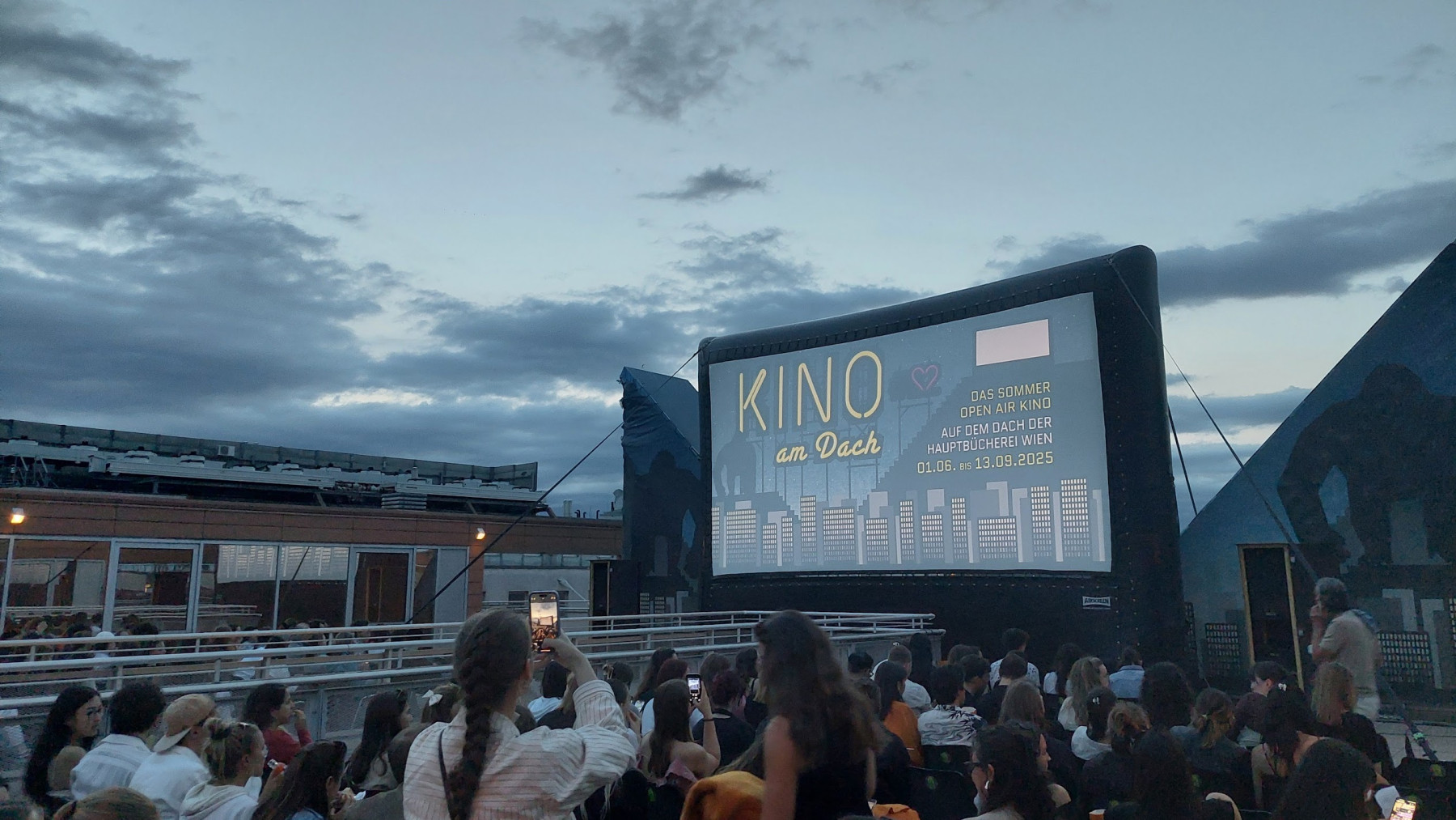 The screen at the Kino am Dach rooftop open-air cinema at dusk in Vienna