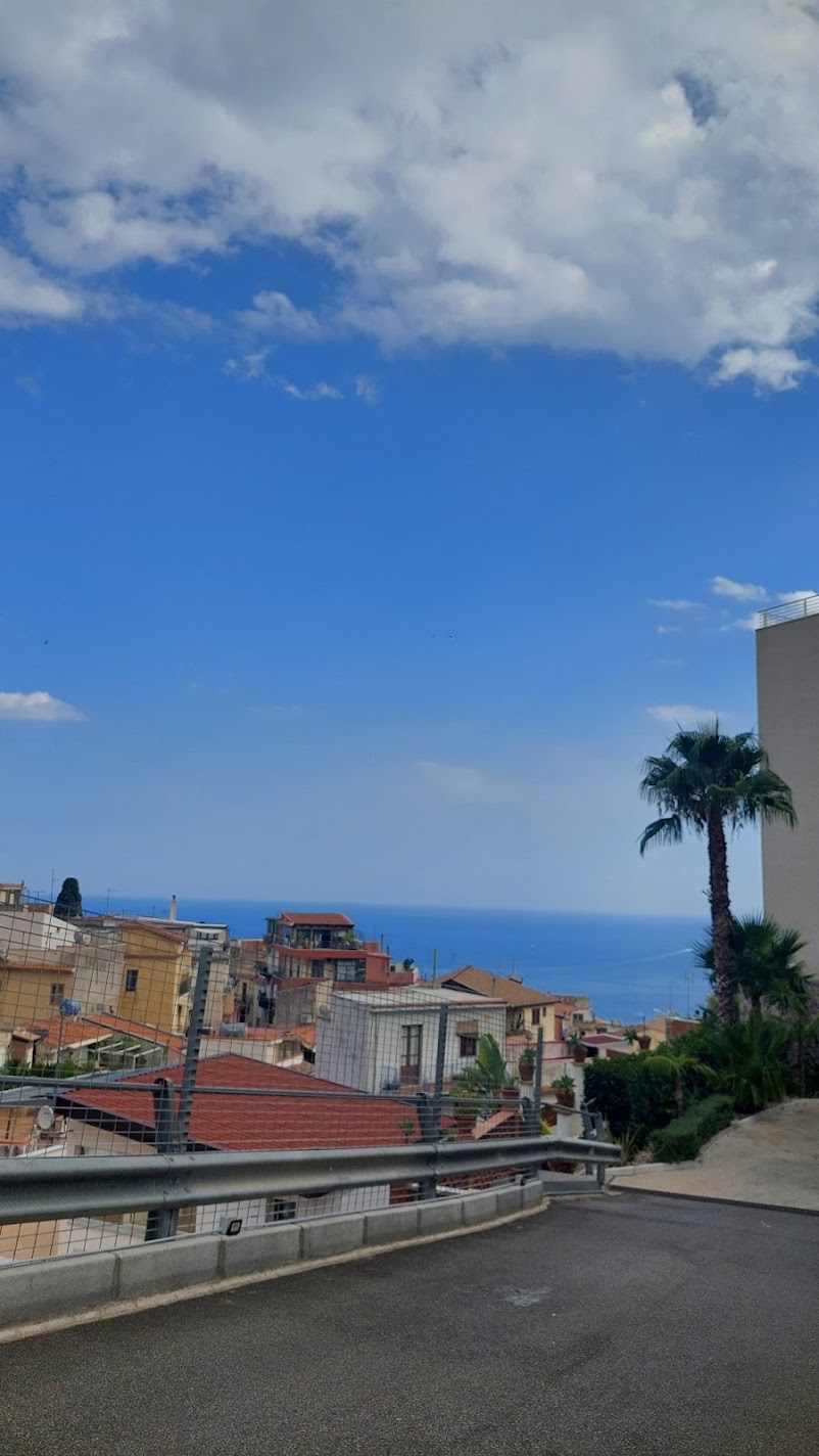 A view over the rooftops of Taormina to the Ionian Sea from a hilltop road