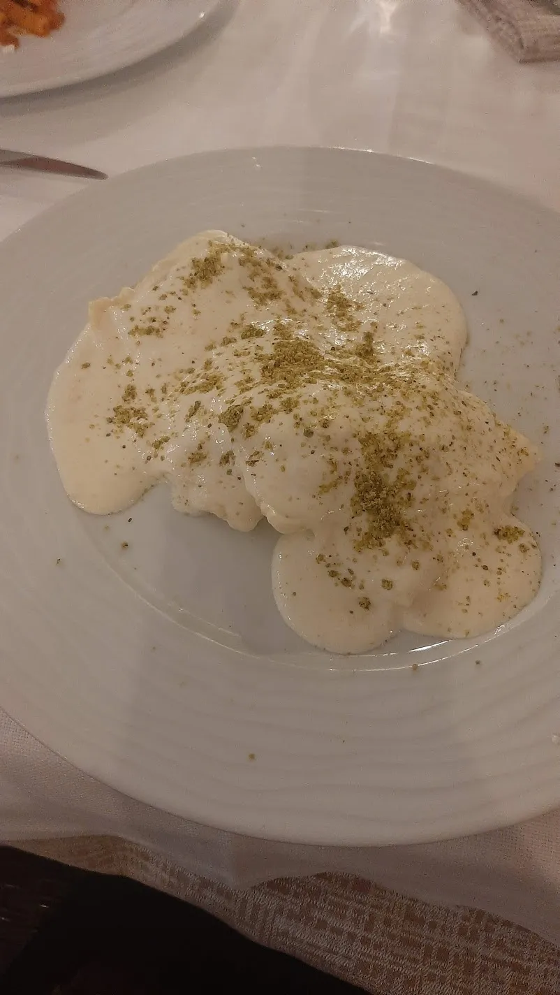 Ravioli in a creamy sauce dusted with ground pistachio, served in Taormina